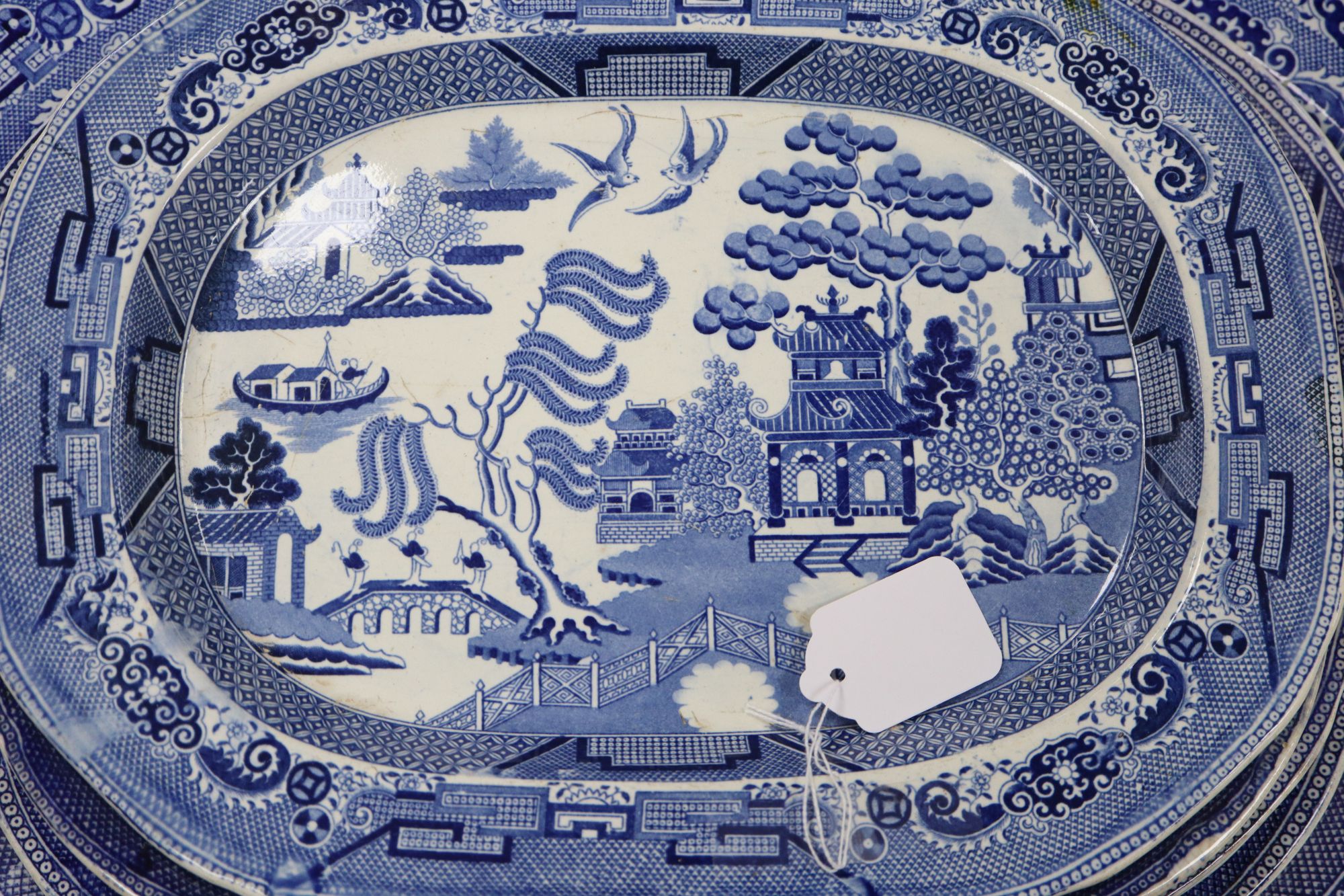 A 19th century transfer-printed large blue and white platter and seven similar smaller platters